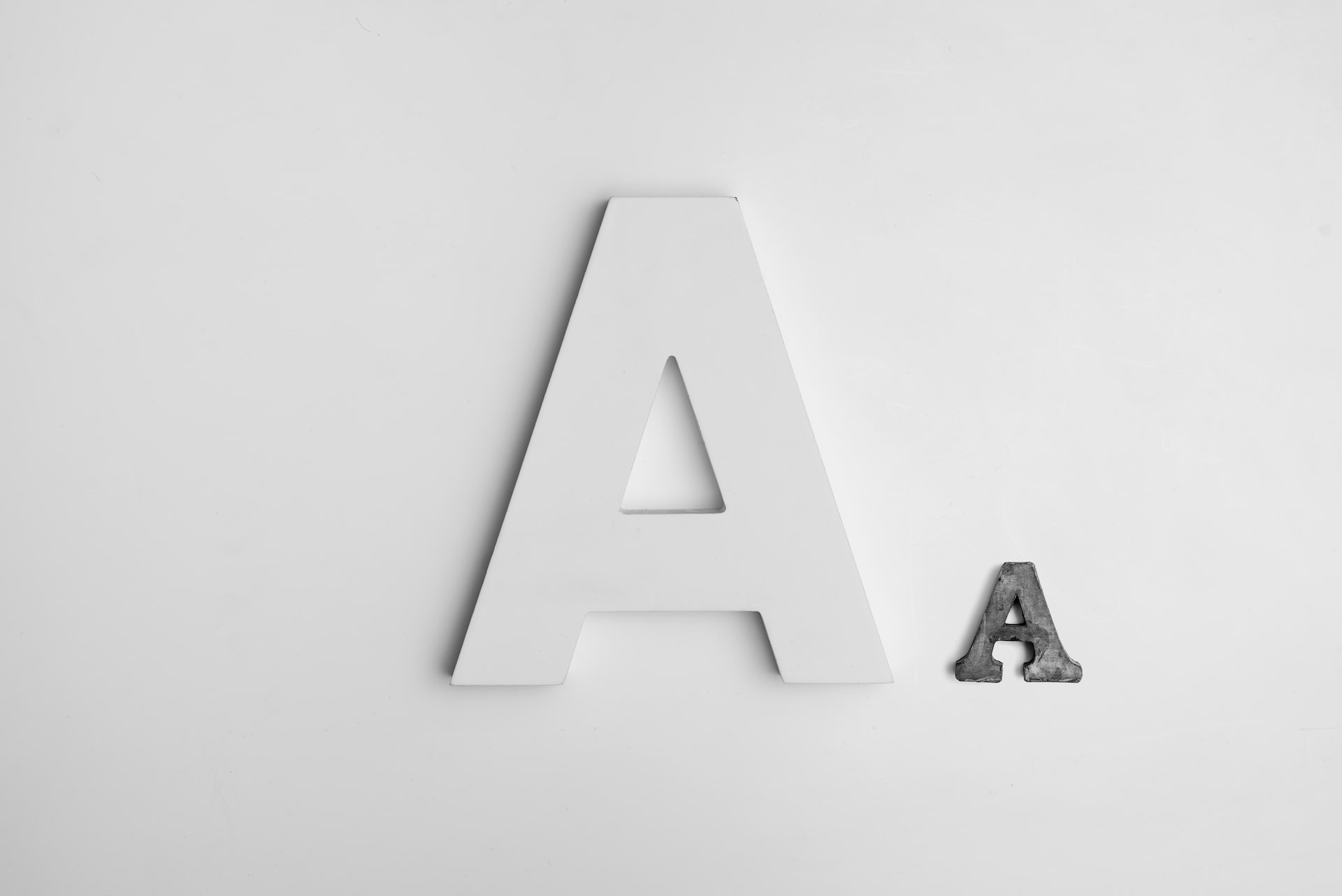A graphic showing a large white capital A and a much smaller gray capital A beside it